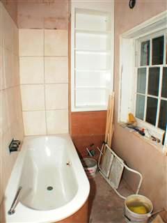 bathroom with shelving and tiles